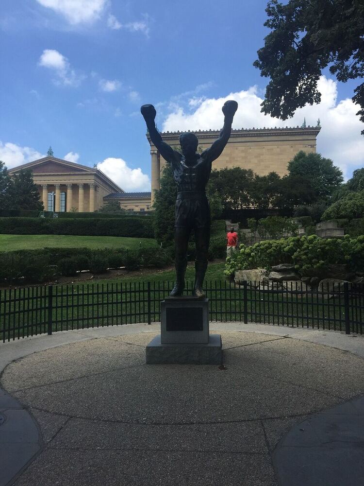The bronze Rocky Balboa statue with arms raised, the Philadelphia Museum of Art behind