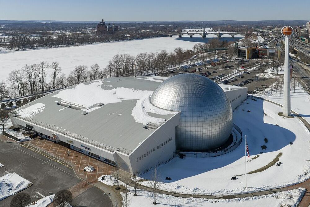 The silver sphere of the Naismith Memorial Basketball Hall of Fame in snow