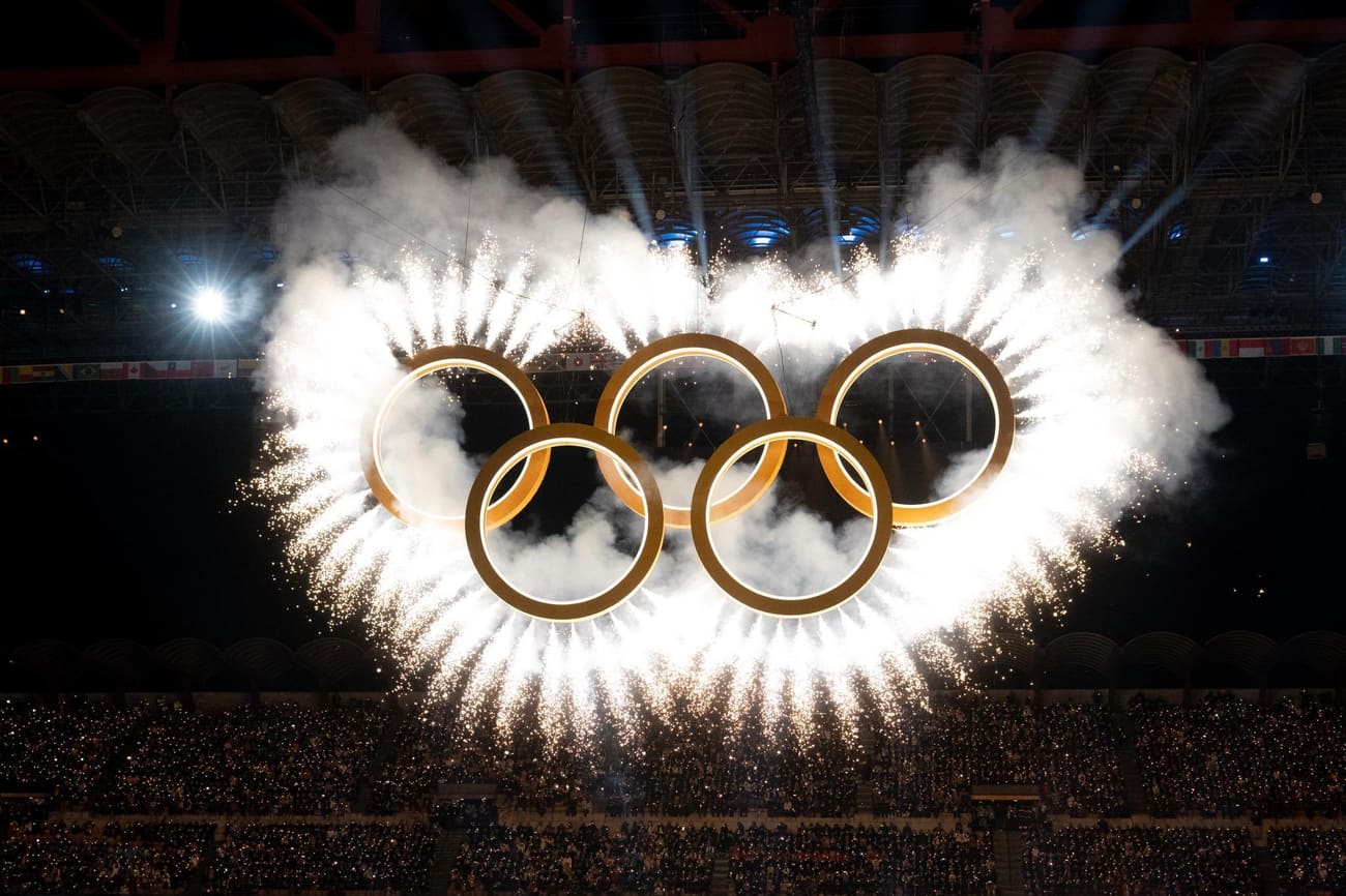 The Olympic rings lit with fireworks during the 2026 Winter Olympics opening ceremony